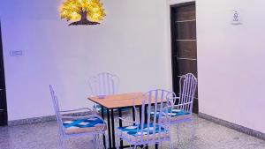 mesa de comedor con sillas y lámpara de araña en Hotel Tree of heaven, en Udaipur