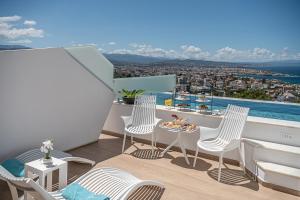 a balcony with chairs and a table with a view at Lagon Life Spirit Boutique Hotel - Adults Only in Chania