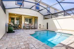 a swimming pool in the backyard of a house at Beautiful Townhome wPool &FREE Resort Access in Kissimmee
