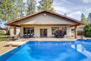 a house with a swimming pool in front of a house at Spokane Valley Vacation Rental with Shared Pool! in Spokane Valley