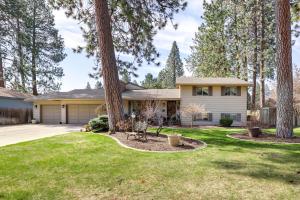 a house with a tree in the yard at Spokane Valley Vacation Rental with Shared Pool! in Spokane Valley