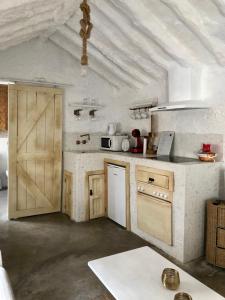 a kitchen with wooden cabinets and a white ceiling at Arya's Nest in Mijas