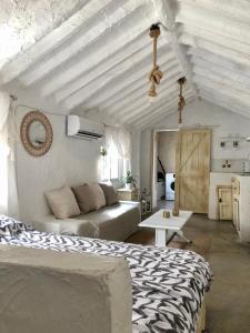 a living room with a bed and a couch at Arya's Nest in Mijas