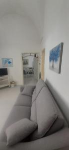 uma sala de estar com um sofá e uma pintura na parede em Da Zia Betty casa vacanza em Maruggio