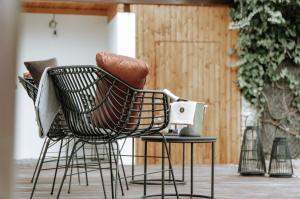 a chair sitting on a table in a patio at Apartments of Hana Hegerová in Hurbanovo