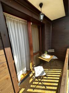 a patio with a table and a chair on a porch at Guest Rooms Melsambria in Nesebar