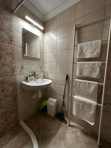 a bathroom with a sink and a shower with a mirror at Guest Rooms Melsambria in Nesebar