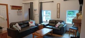a living room with two couches and a coffee table at Bovinda Cottage - By the Beach, Bettystown in Bettystown