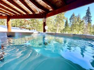 a large swimming pool with blue water at Tranquil Cabin - Private Hot Tub And Fire Pit! in Duck Creek Village
