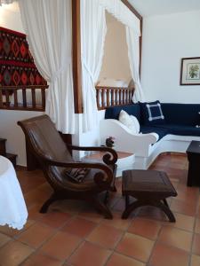 a living room with a chair and a couch at Evelinas Apartement in Kalymnos