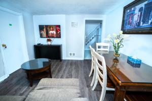 a living room with a dining room table and a table and chairs at Cozy 3BR 2Bth Lower Unit, A min to Hwy401, 404 & DVP in Toronto