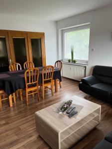 a living room with a table and a couch at Apartment Geronimo in Werne an der Lippe