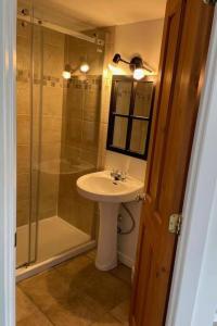 a bathroom with a sink and a shower at Tremblant Village Retreat!Steps to hill & trails in Mont-Tremblant
