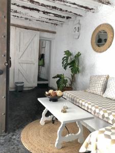 a living room with a table and a couch at Arya's Nest in Mijas