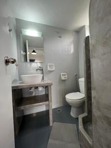 a bathroom with a sink and a toilet at Spanos Apartments - Panteli in Panteli