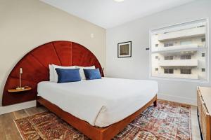 a bedroom with a large bed and a window at Roami at The Carmela in Miami Beach