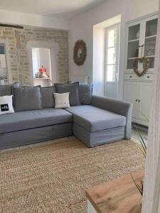 a blue couch in a living room with a rug at Détente et vue exceptionnelle à L'appart' de Charles in Dole