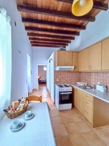 a kitchen with a table and a counter top at The Old barrel houses in Kythira