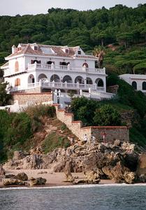 a large white house on top of a mountain at Hostal Mar de Frente in Los Caños de Meca