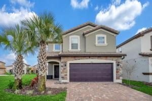 a house with a garage and palm trees at 5532 Misty Oak Circle in Davenport