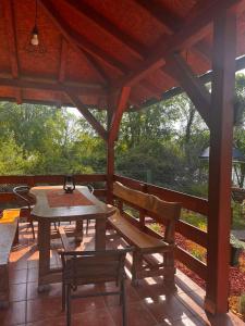 a patio with a table and chairs on a porch at Studio Vikendica Bele Vode in Banja Koviljača