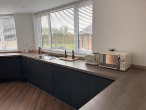 a kitchen with a counter top with a microwave at No 1 Chestnut Grove in Withernsea