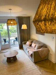 a living room with a couch and a table at La Maison Régent & spa face à la mer in Pornichet