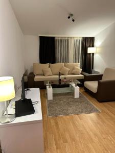 a living room with a couch and a table at Aspen Luxury Apartamnet in Razlog