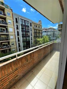 a balcony with a brick wall and some buildings at París Habitaciones in Barcelona
