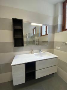 a bathroom with a white sink and a mirror at Casa Ahmati Borgo Vesio in Tremosine Sul Garda