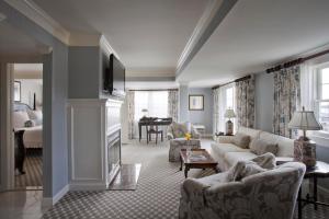 a living room with a couch and a fireplace at Saybrook Point Resort & Marina in Old Saybrook