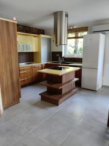 a kitchen with a white refrigerator and wooden cabinets at Bungalov Valentýna in Mikulov