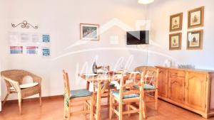 a dining room with a table and chairs at SA TORRETA 4 in Cala Blanca