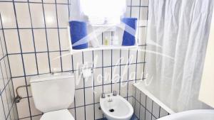 a bathroom with a white toilet and a sink at SA TORRETA 4 in Cala Blanca +29 photos