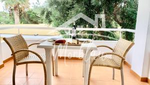 a white table and chairs on a balcony at SA TORRETA 4 in Cala Blanca