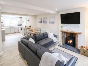 a living room with a couch and a fireplace at 4 Railway Terrace in Conwy
