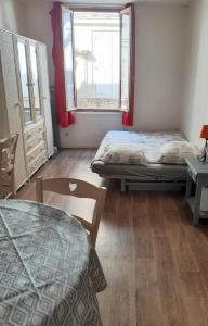 a room with two beds and a window at Studio intra-muros 5mn gare centre in Avignon