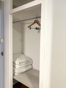 a closet with a stack of folded towels on a shelf at Hacienda Guadalquivir in Córdoba