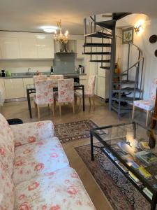 a living room with a couch and a table with chairs at Ferienhaus, Rustico Auf Burg in Locarno