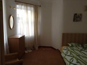 a bedroom with a bed and a dresser and a window at Cheap And Chic in Rīga +47 photos