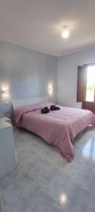 ein Schlafzimmer mit einem großen rosa Bett in einem Zimmer in der Unterkunft Tenuta Valle Incanto in Locorotondo