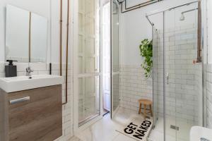 a bathroom with a shower and a sink at The Urban Jungle Hostel in Málaga