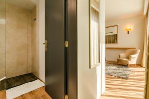 a hallway with a door leading to a living room at Calheta Tangerine House in Arco da Calheta +19 photos