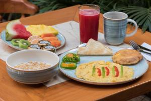 una mesa con dos platos de desayuno y una bebida en Hotel Boutique La Artilleria, en Cartagena de Indias