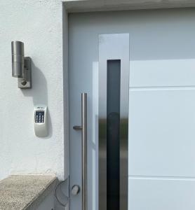 a glass door with a phone on the side of a building at Appartement -Villa ROYAL Hélène in Oberlauterbach