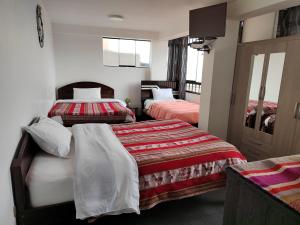 Hostal Killaly Inn Cusco客房内的一张或多张床位