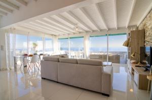 a living room with a couch and a table at Penthouse of Views Los Cristianos in Los Cristianos