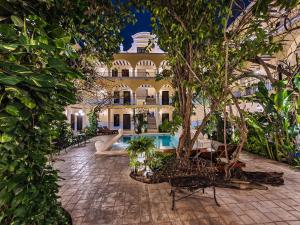 a resort with a swimming pool and a building at Hotel Fundadores in Valladolid +37 photos