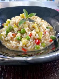 a plate of rice and vegetables on a table at Hotel Kristal Borsh in Borsh