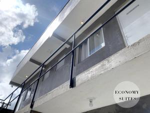 a building with large windows on the side of it at Pousada BRAWAY in Curitiba